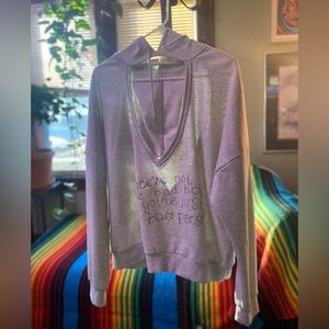 Cut-out tan hoodie. Hole one chest and back. Hand stitching front.